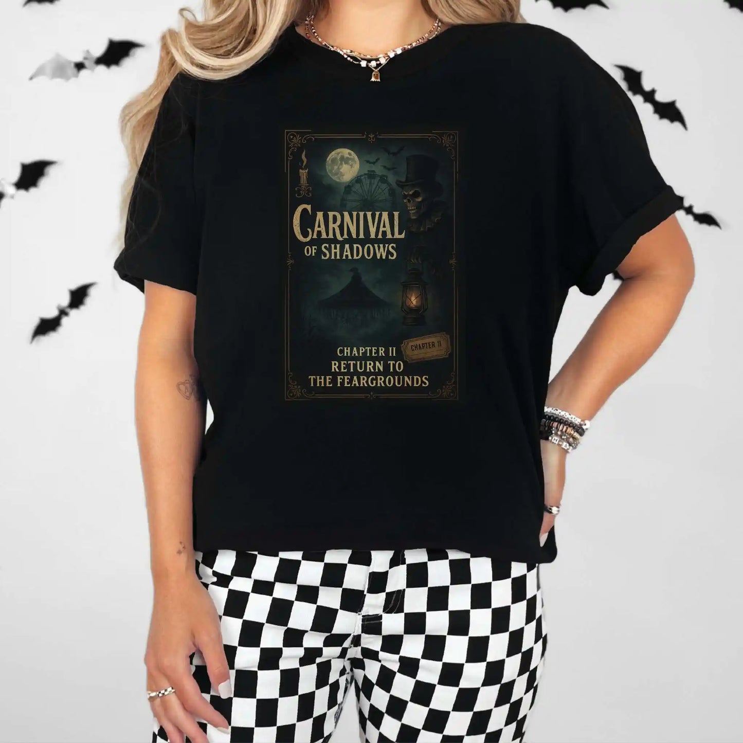 Person wearing a black t-shirt with 'Carnival of Shadows' design, standing against a white background with black bats.