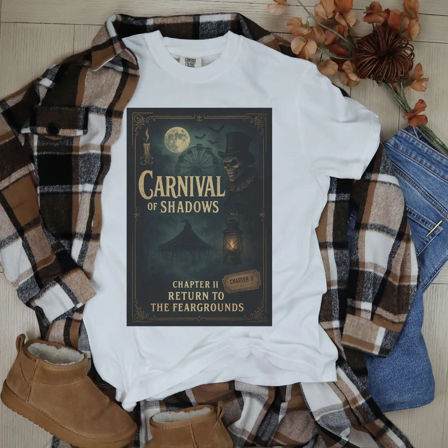 White t-shirt with 'Carnival of Shadows' design on a plaid shirt and jeans with boots.