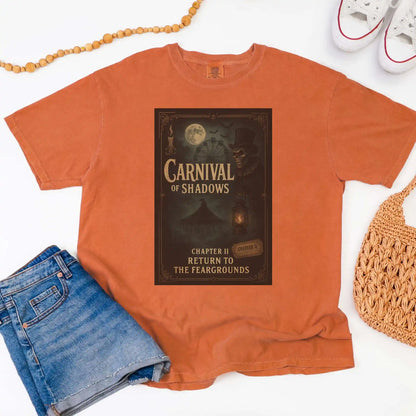 Yam colored t-shirt with 'Carnival of Shadows' graphic design on a white background
