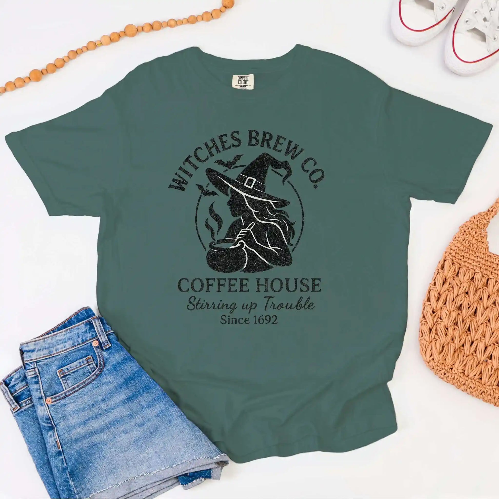 Green t-shirt with 'Witches Brew Co. Coffee House' design on a white background