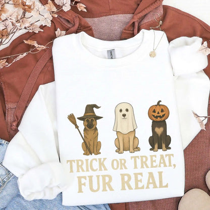 White sweatshirt with Halloween-themed dog illustrations and "Trick or treat fur real" text on a brown jacket and jeans background.