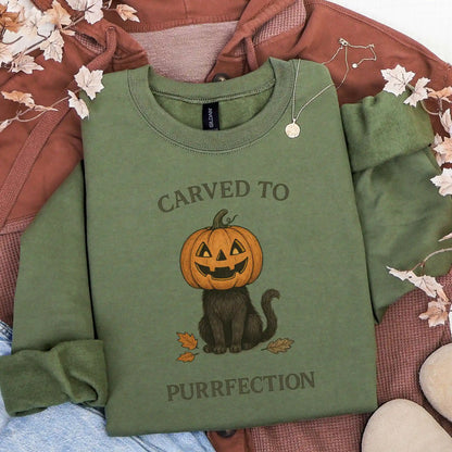 Military Green sweatshirt with a Halloween design of a cat with a pumpkin head and text 'Carved to Purrfection' on a brown jacket background.