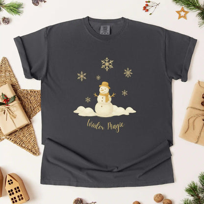 Dark grey (pepper) colored t-shirt with a snowman design and 'Winter Magic' text, surrounded by Christmas wrapping and decorations