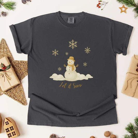 Dark gray colored t-shirt with a snowman design and 'Let it Snow' text, surrounded by Christmas wrapping and decorations.