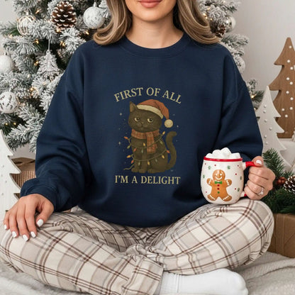 Person wearing a navy sweatshirt with a cat Christmas-themed design, holding a mug, in a festive setting.